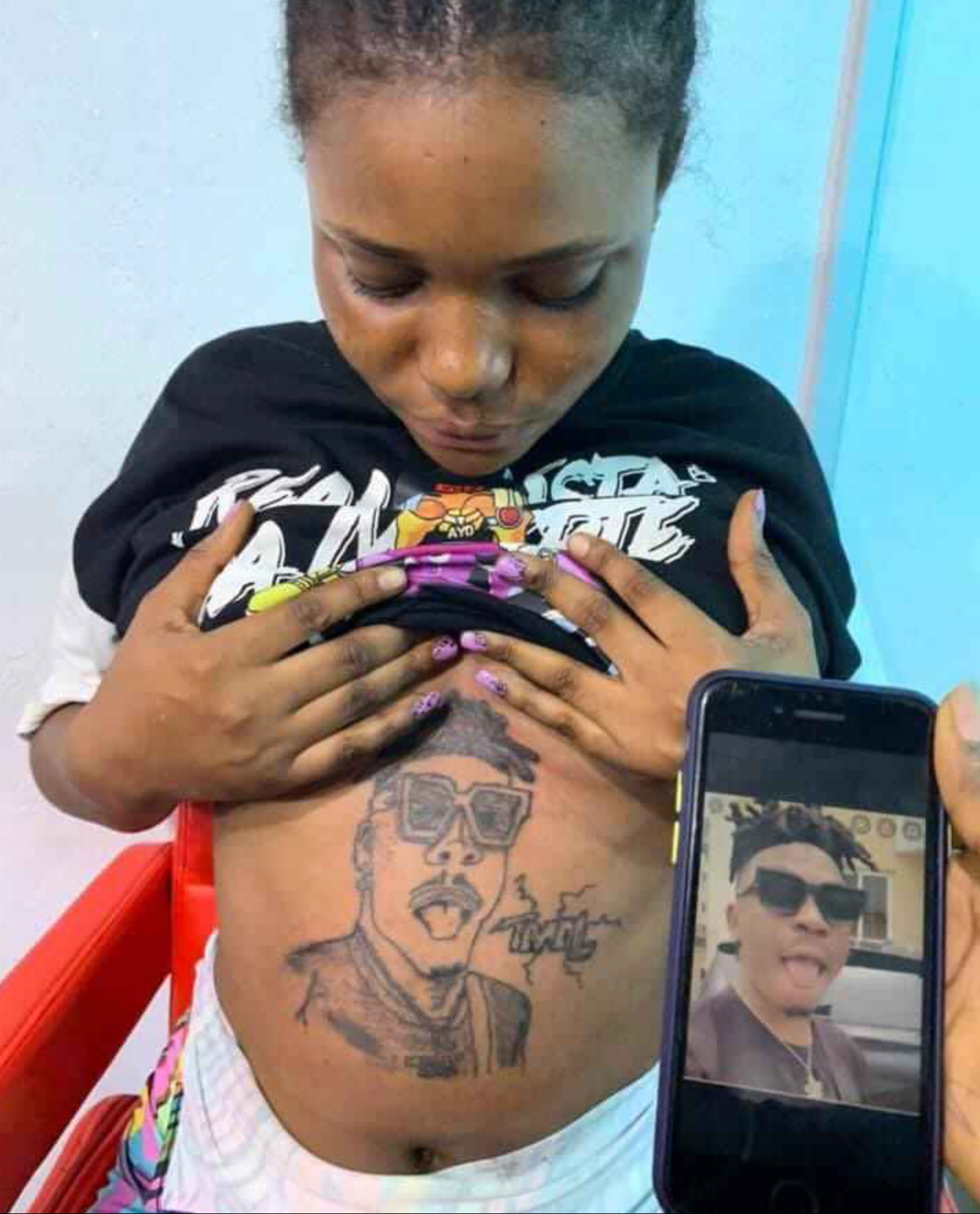 Pregnant Lady Does A Tattoo Of Mayorkun On Her Stomach