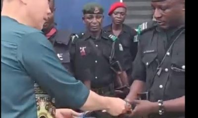 Nigerian Police officers Queue Cash