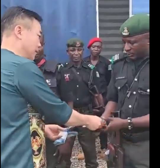 Nigerian Police officers Queue Cash